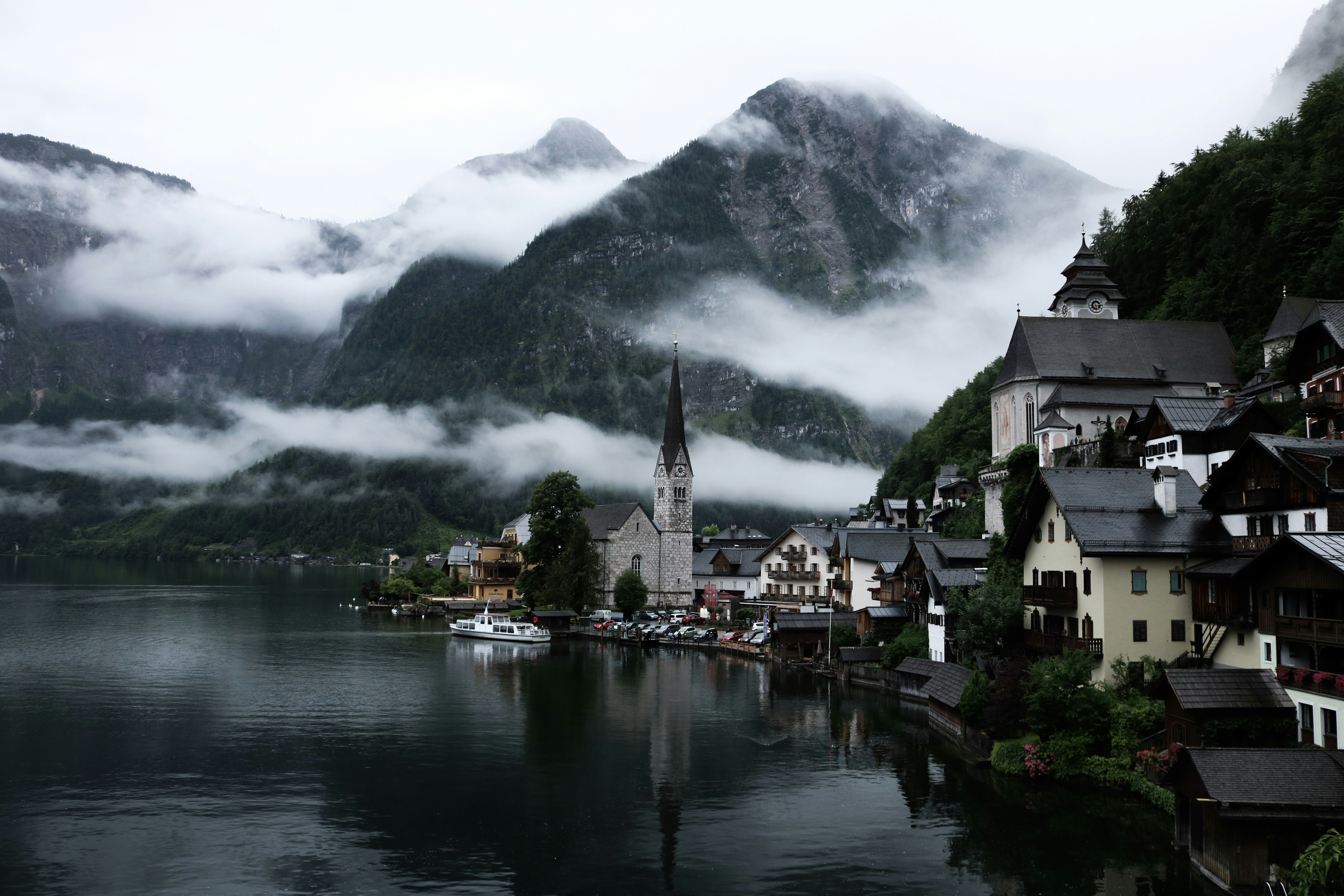 village near lake surrounded by fogs